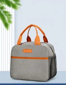Close-up of gray Oxford fabric insulated lunch bag featuring orange webbing and side mesh pocket