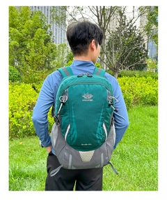 Outdoor 40L hiking backpack in green shown on male model in a natural setting