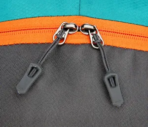 Detail of durable two-way zippers with non-slip pulls on waterproof hiking backpack
