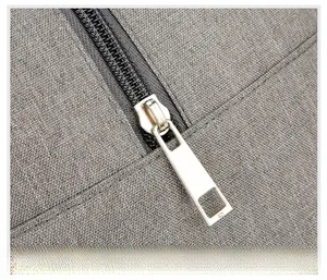 Close-up of durable silver metal zipper and grey woven fabric on the lunch bag