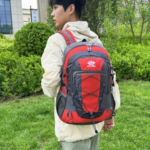 Large red and grey outdoor hiking backpack with bungee cords and ergonomic shoulder straps