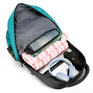 Large teal outdoor hiking backpack showing open main compartment with travel essentials