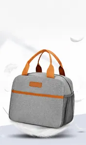 Macro detail of lightweight grey oxford cloth insulated lunch bag with orange accents