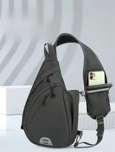 Detail of grey crossbody sling bag featuring a dedicated shoulder strap phone pocket