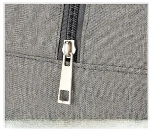 Detail of durable metal zipper puller on gray Oxford fabric insulated lunch bag