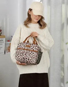 Detail of leopard print insulated lunch bag with side mesh pocket and sturdy handles