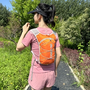 Lightweight orange hydration backpack for trail running and outdoor marathon sports
