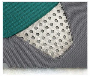 Macro detail of outdoor backpack showing honeycomb texture and silver perforated panel