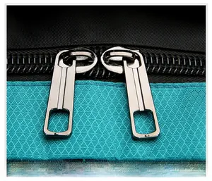 Detail of durable dual metal zippers and ripstop nylon fabric on the outdoor backpack