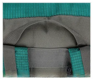 Close-up of durable reinforced gray handle on dark green honeycomb textured outdoor backpack