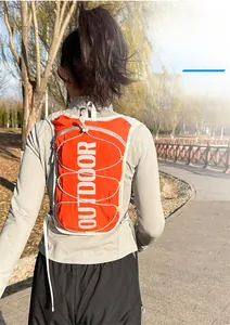 Outdoor shot of a lightweight reflective running vest in bright orange with elastic cords