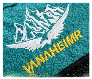 Macro shot of VANAHEIMR logo embroidery and diamond-pattern ripstop nylon fabric