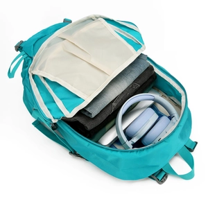 Large teal hiking backpack showing spacious interior with laptop and travel essentials