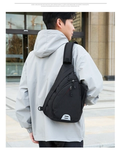 Ergonomic black nylon crossbody bag with wide shoulder strap and side water bottle pocket