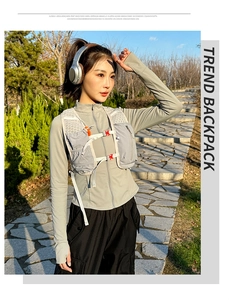 Detail view of breathable mesh running vest with adjustable chest buckles and gray tech fabric