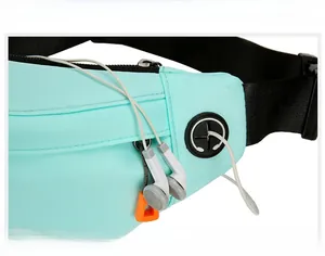 Detail view of the mint green sports waist pack with functional headphone port feature