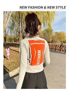 Lightweight orange running vest pack with reflective strips and outdoor print detail
