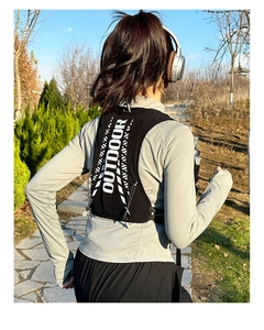 Rear view of lightweight hydration vest with reflective Outdoor text for trail running