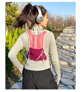 Close-up of a pink breathable running vest with reflective outdoor logo and elastic cords