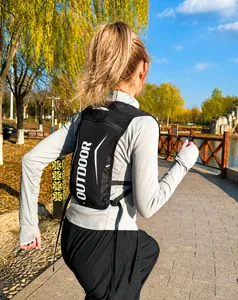 Close-up of lightweight black hydration vest with breathable mesh and OUTDOOR lettering