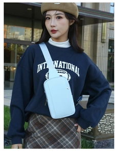 Outdoor model wearing light blue casual crossbody chest bag with adjustable strap