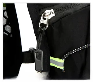 Macro view of KAM metal zipper with nylon pull cord and reflective green detail