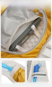 Detail view of hydration backpack featuring water tube outlet and reflective safety straps
