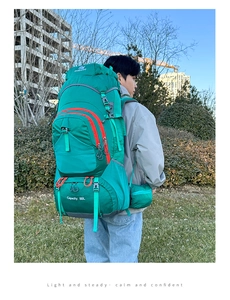 Outdoor 80L large capacity hiking backpack in green with red zipper details worn by a hiker