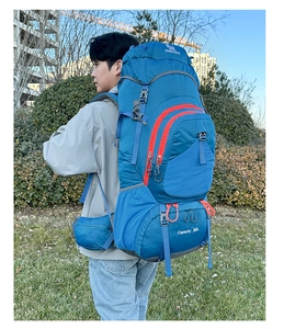 Outdoor model wearing a 80L large capacity blue hiking backpack with orange zippers