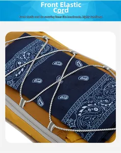 Detail of yellow nylon hiking pack featuring elastic bungee cord holding a blue paisley scarf