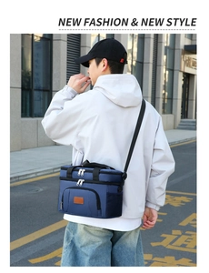 Deep blue insulated picnic bag with adjustable shoulder straps in an outdoor urban setting