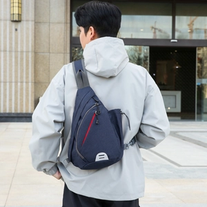 Men's navy blue oxford chest bag with red zipper accents and safety reflective strip