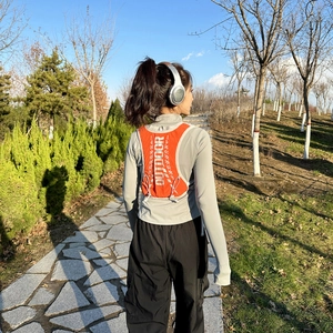 Vibrant orange 5L outdoor running vest with breathable mesh and adjustable drawstring