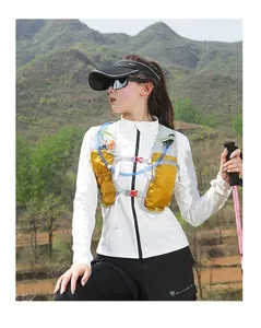 Close-up of yellow hydration vest with water tube, gray mesh, and orange safety whistle