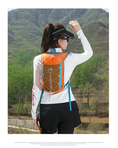 Outdoor view of lightweight orange and brown waterproof nylon vest pack for running