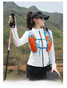 Close-up of lightweight hydration vest with trekking poles in an outdoor hiking scene