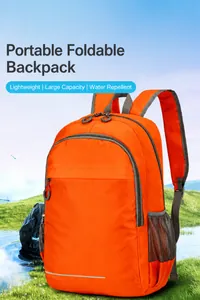 Close-up of bright orange water-resistant foldable backpack with reflective safety strip