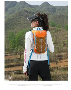 Orange trail running vest backpack shown in mountain setting with trekking poles