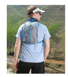 Detail of outdoor hydration vest with blue elastic cords on grey fabric during hiking