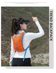Outdoor hydration pack detail showing orange fabric and blue straps for hiking