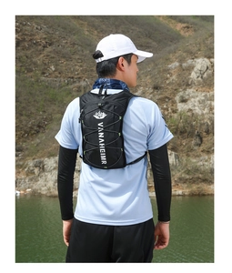 Outdoor view of a black cycling backpack with adjustable elastic cords for hiking
