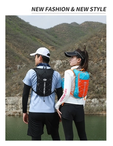 Outdoor running vests in black and blue-orange colors with elastic net shown in nature