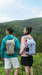 Detailed view of ultralight hiking backpacks in beige and light blue during outdoor hiking