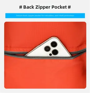 Detail showing back anti-theft zipper pocket on red outdoor backpack with phone inside