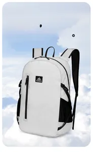 Macro shot of white lightweight hiking backpack with AZELA logo on outdoor background