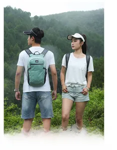 Outdoor hikers wearing mint green lightweight folding backpacks on a mountain trail