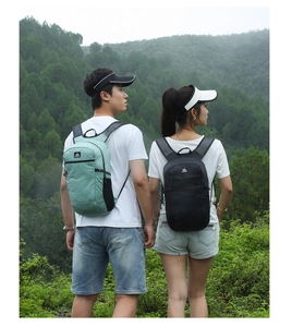 Rear view of hikers wearing lightweight mint green and black outdoor backpacks in the mountains