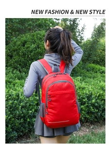 Close-up of the red water-resistant nylon backpack featuring multi-pocket design for hiking