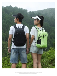 Outdoor hiking backpacks in black and neon green shown in a scenic mountain landscape
