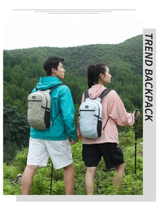 Close-up of lightweight hiking backpacks in grey and beige colors with side mesh pockets